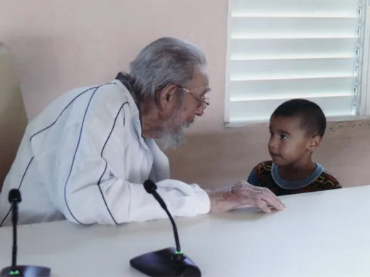 Fidel Castro conversa con un niño en el complejo educacional Vilma Espín